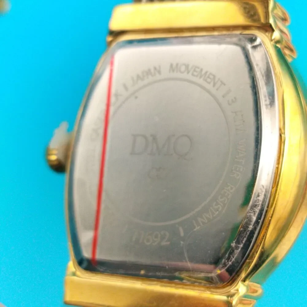 DMQ Women's Gold Tone Cubic Zirconia Mother of Pearl Dial Cable Bangle Watch